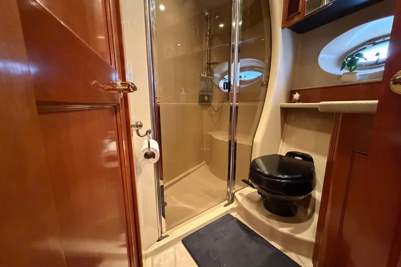 Slide: The Image of Luxurious bathroom in 2003 Cruisers Yachts 5470 Express with shower and porthole window. - 32