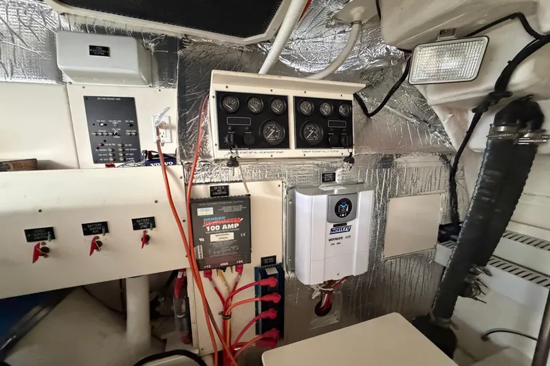 Slide: The Image of Engine room of 2003 Cruisers Yachts 5470 Express with control panels and wiring. - 43