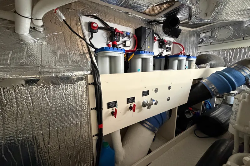 Slide: The Image of Engine room of 2003 Cruisers Yachts 5470 Express with filtration system and insulated walls. - 45