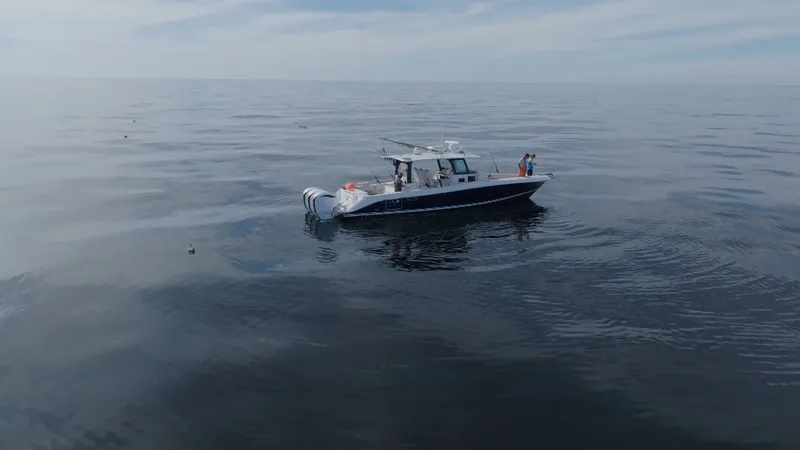 Slide: The Image of A 2023 HCB 42 Lujo on calm waters with a clear sky. - 15