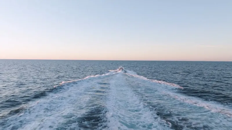 Slide: The Image of A 2023 HCB 42 Lujo speeds across the open sea, leaving a wide wake behind. - 10