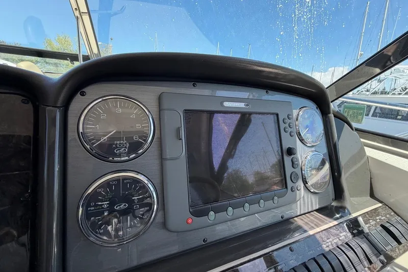 Slide: The Image of Dashboard of a 2007 Sea Ray 380 Sundancer boat with gauges and navigation screen. - 17
