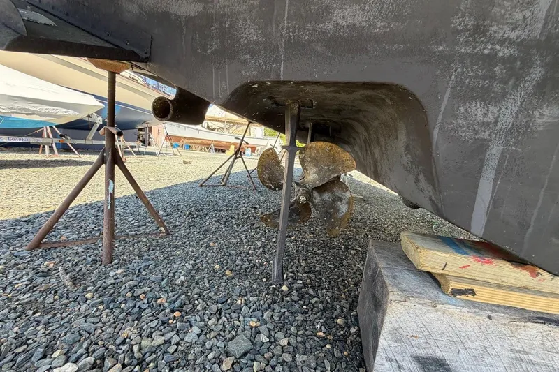 Slide: The Image of 2007 Sea Ray 380 Sundancer propeller and hull on dry dock, supported by stands. - 7