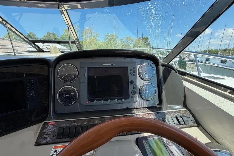 Slide: The Image of Cockpit view of 2007 Sea Ray 380 Sundancer with navigation instruments and steering wheel. - 18
