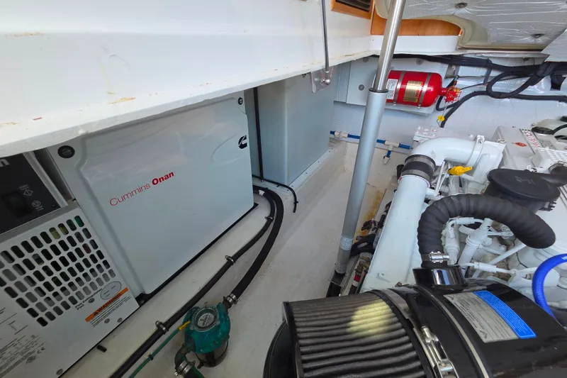 Slide: The Image of Engine room of 2018 Back Cove 37 with Cummins Onan generator and fire extinguisher. - 96