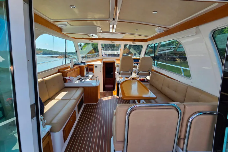 Slide: The Image of Interior of a 2018 Back Cove 37 yacht with elegant seating and wooden finishes. - 82