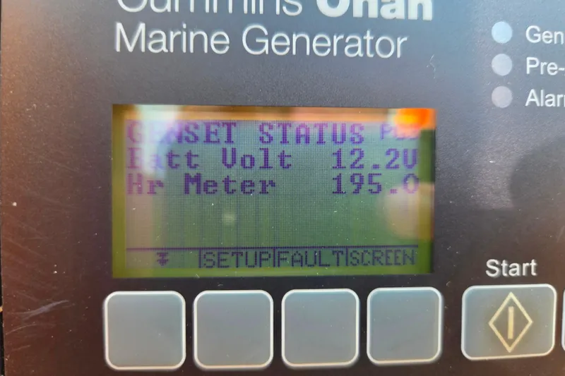 Slide: The Image of Cummins Onan marine generator display showing battery voltage and hour meter readings. - 67