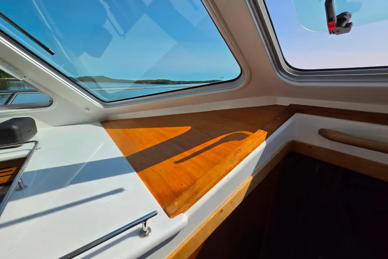 Slide: The Image of Interior view of 2018 Back Cove 37 boat with wooden accents and large windows. - 69