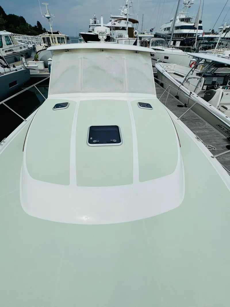 Slide: The Image of The image shows the deck of a 2018 Back Cove 37, docked in a marina. - 15
