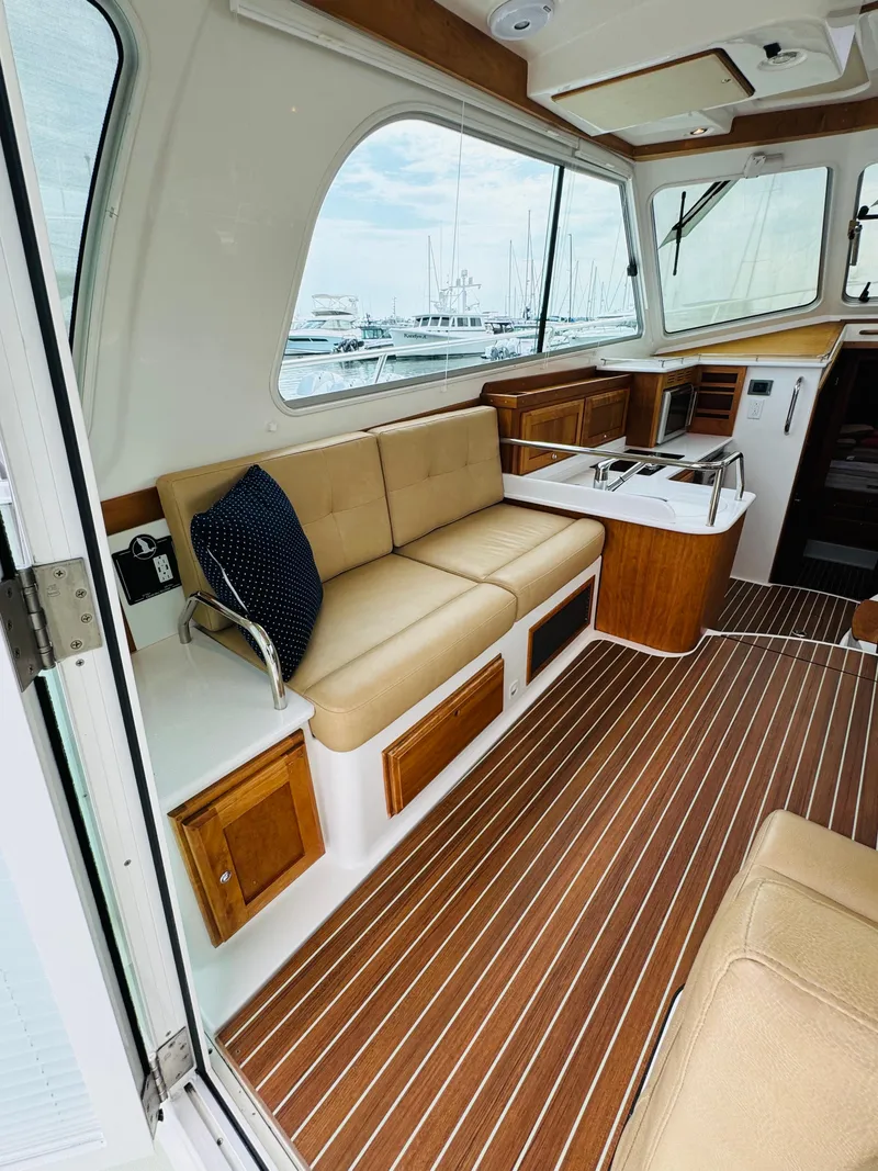 Slide: The Image of Interior of a 2018 Back Cove 37 with wood flooring and beige sofa. - 30