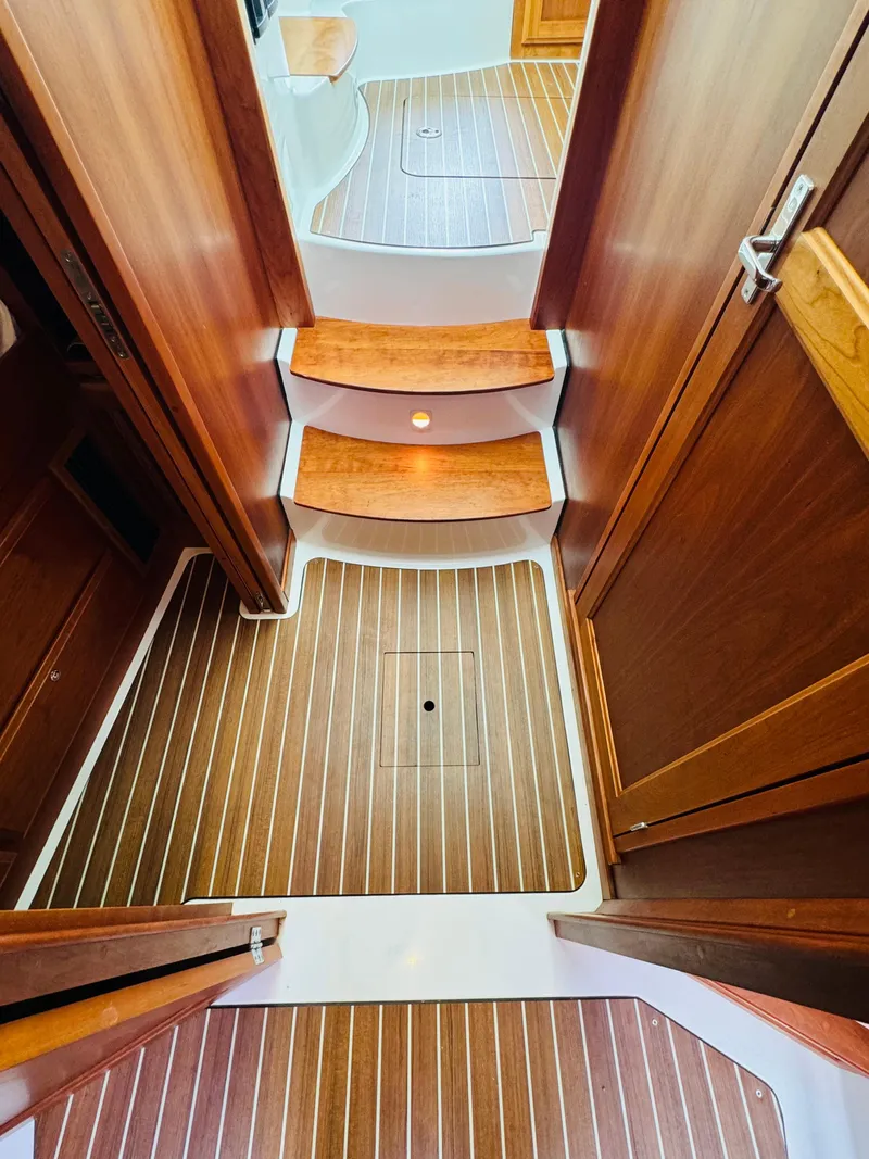 Slide: The Image of Interior of a 2018 Back Cove 37 with wood paneling and striped flooring. - 38