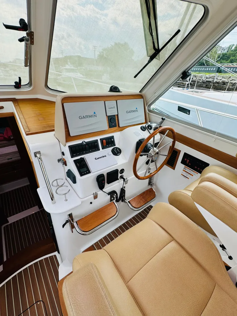 Slide: The Image of Interior of a 2018 Back Cove 37 with a modern helm and comfortable seating. - 48