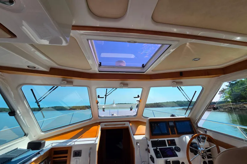 Slide: The Image of Interior view of 2018 Back Cove 37 boat cockpit with scenic waterway. - 68