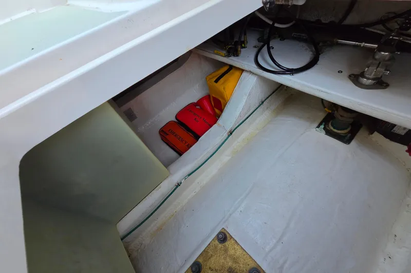 Slide: The Image of Interior storage compartment of a 2018 Back Cove 37 boat with emergency kits. - 88