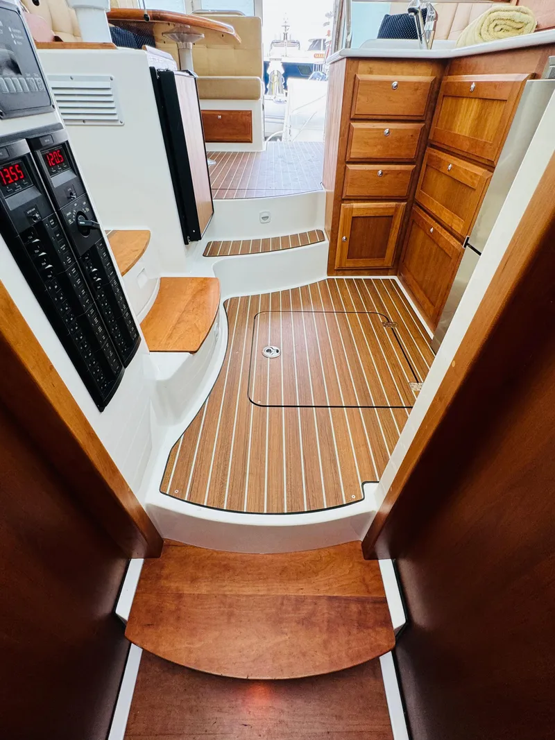 Slide: The Image of The interior view of a 2018 Back Cove 37 features elegant wood flooring and cabinetry. - 40