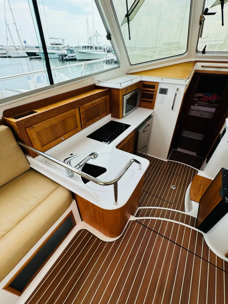 Slide: The Image of Interior of a 2018 Back Cove 37 featuring a sleek kitchen and wooden flooring. - 42