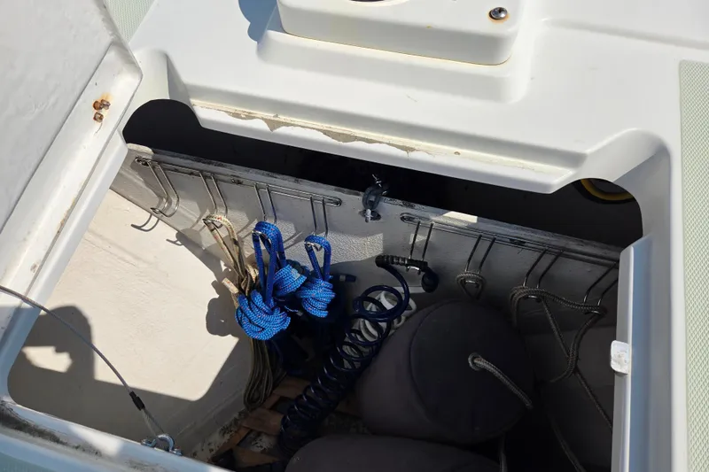 Slide: The Image of Storage compartment on a 2018 Back Cove 37 boat with ropes and hooks. - 66