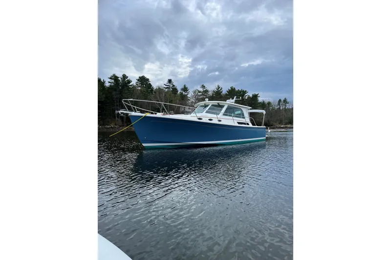 The Image of 2018 Back Cove 37 boat on calm water under cloudy sky. - 0