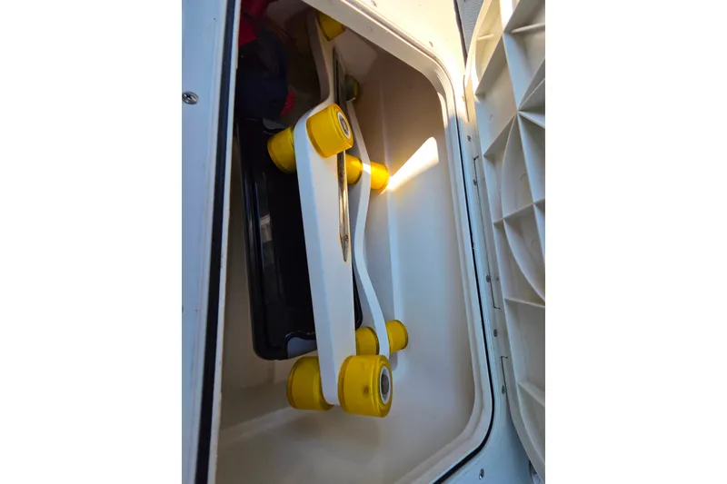 Slide: The Image of Storage compartment in a 2018 Back Cove 37 boat with yellow rollers. - 101