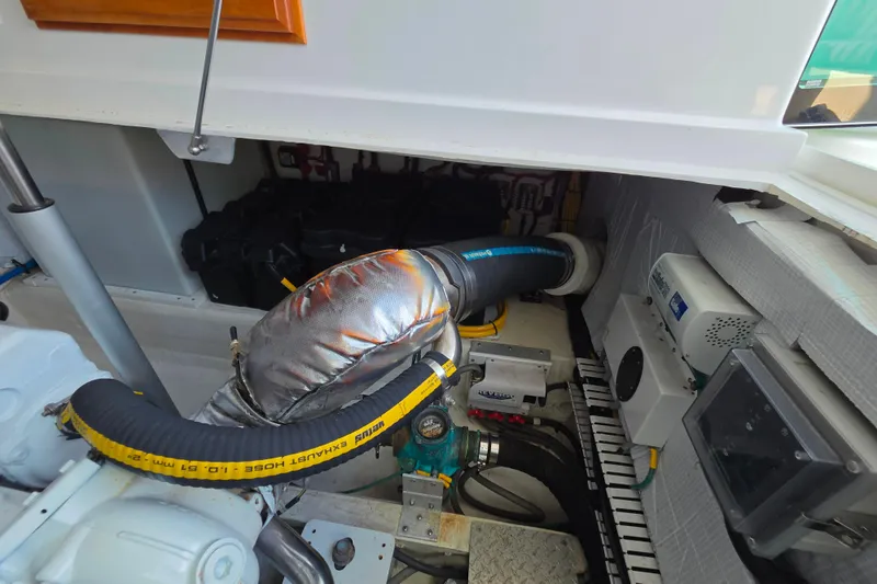 Slide: The Image of Engine compartment of a 2018 Back Cove 37 boat, showcasing mechanical components. - 84