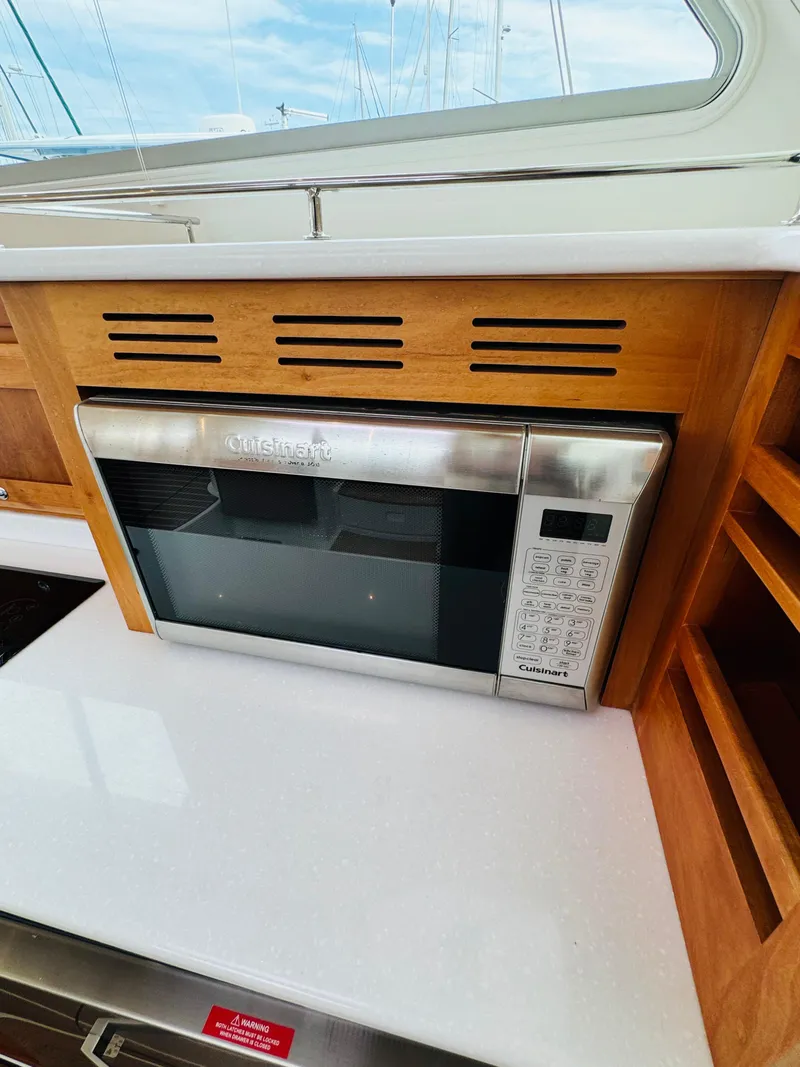 Slide: The Image of A microwave is built into a wooden galley on a boat. - 45