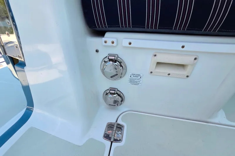 Slide: The Image of 2018 Back Cove 37 boat deck with power outlets and striped seating. - 100