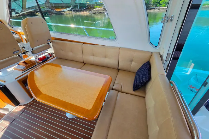 Slide: The Image of Luxurious interior of 2018 Back Cove 37 yacht with plush seating and wooden table. - 80