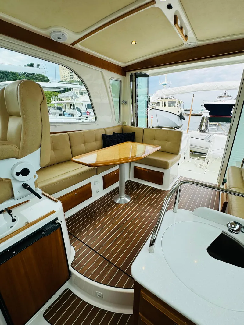 Slide: The Image of Interior of a 2018 Back Cove 37 featuring an elegant seating area and wooden table. - 28