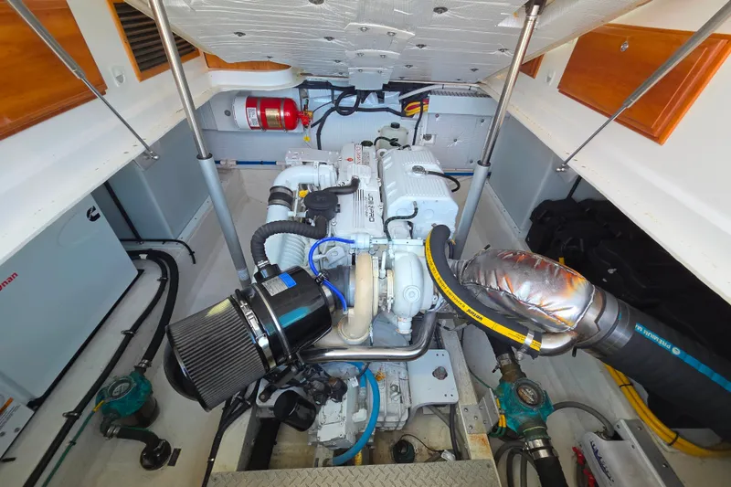 Slide: The Image of Engine room of a 2018 Back Cove 37 boat, showcasing detailed mechanical components. - 98