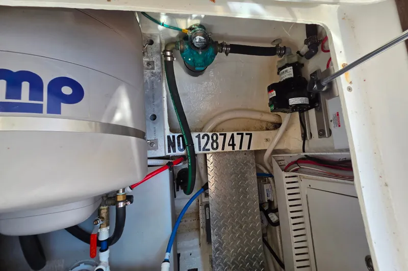 Slide: The Image of Engine compartment of a 2018 Back Cove 37 boat, featuring various mechanical components. - 102