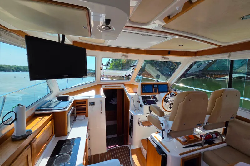 Slide: The Image of Interior of 2018 Back Cove 37 yacht with helm, seating, and panoramic windows. - 71