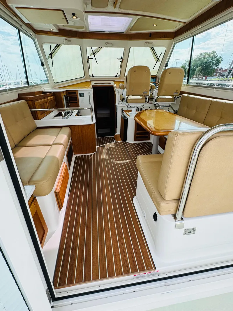 Slide: The Image of Interior of the 2018 Back Cove 37 with elegant wood flooring and comfortable seating. - 23