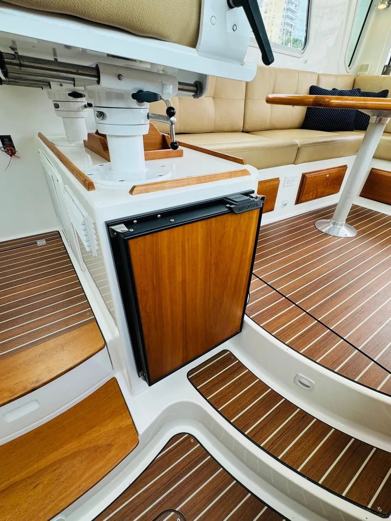 Slide: The Image of Interior of a 2018 Back Cove 37 with wood flooring and a small refrigerator. - 44