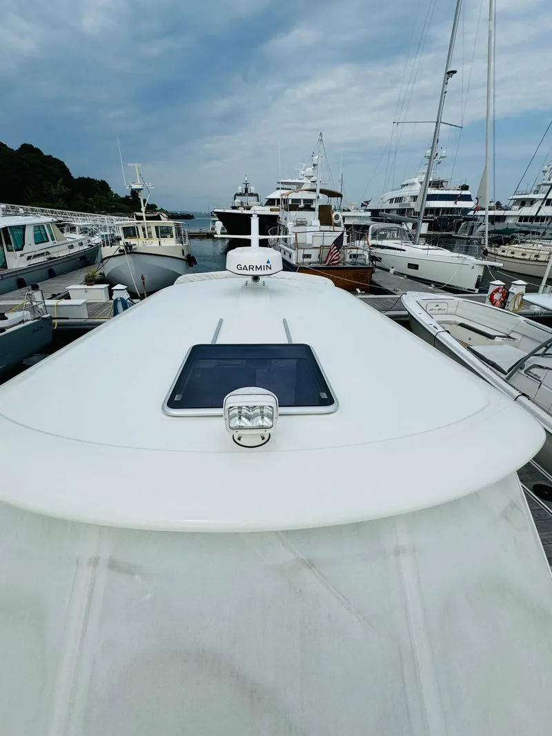 Slide: The Image of The image shows the deck of a 2018 Back Cove 37, docked in a marina. - 17