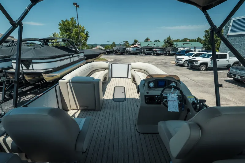 Slide: The Image of 2022 Cypress Cay Seabreeze 252 pontoon boat interior at a marina with parked vehicles. - 29
