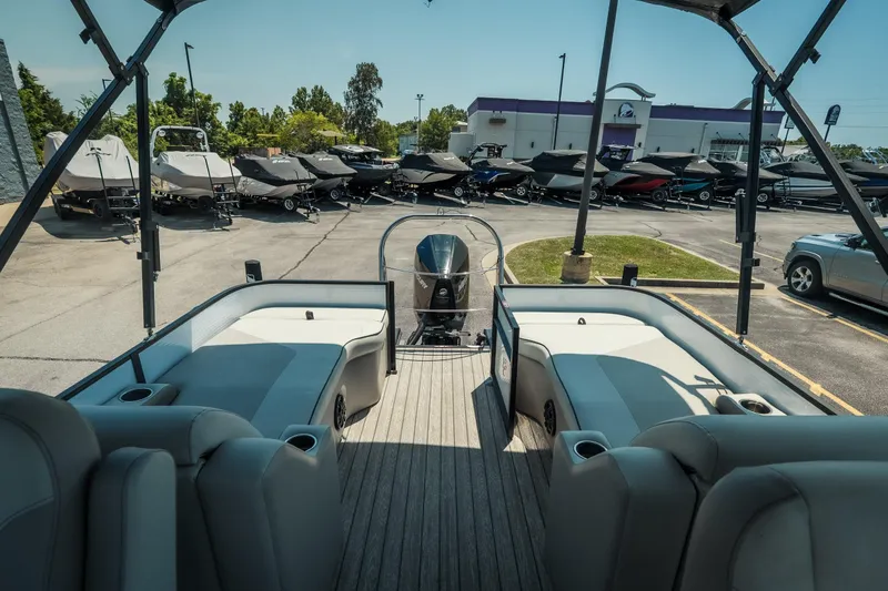 Slide: The Image of 2022 Cypress Cay Seabreeze 252 pontoon boat interior with seating, parked in a dealership lot. - 28