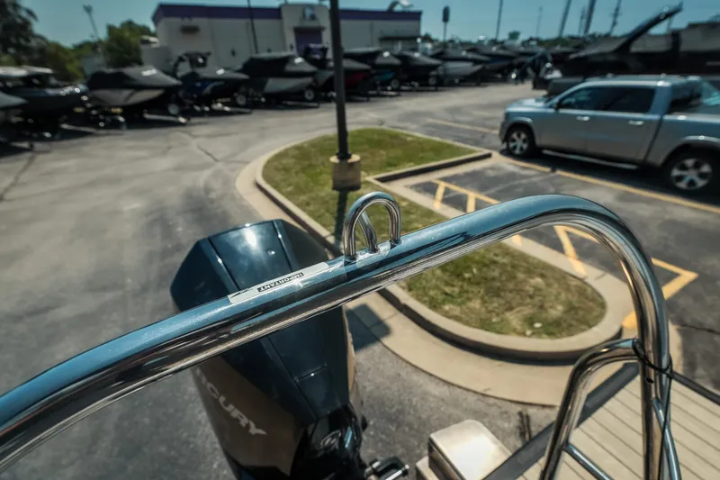 Slide: The Image of 2022 Cypress Cay Seabreeze 252 boat detail with Mercury engine in parking lot. - 22