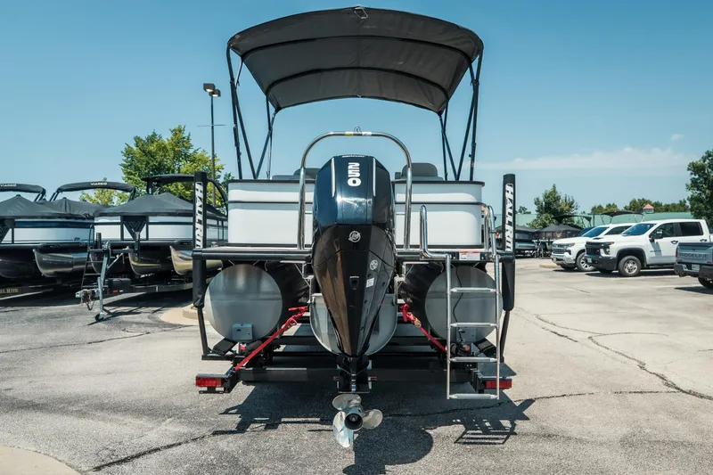 Slide: The Image of 2022 Cypress Cay Seabreeze 252 pontoon boat with outboard motor, parked in a lot. - 4