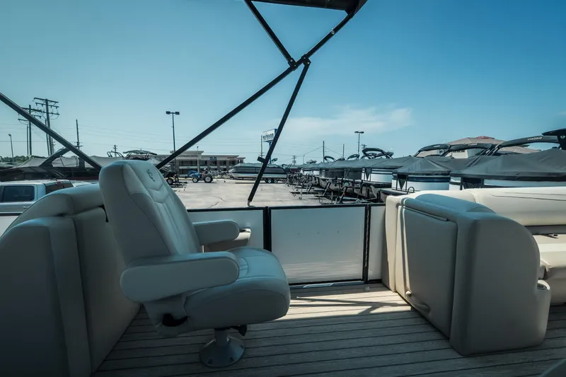 Slide: The Image of 2022 Cypress Cay Seabreeze 252 pontoon boat interior with plush seating and open deck. - 18