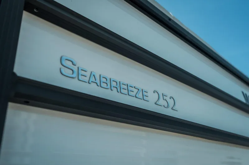 Slide: The Image of 2022 Cypress Cay Seabreeze 252 boat nameplate on sleek exterior. - 14