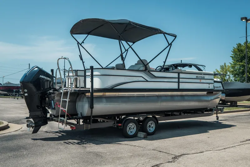 Slide: The Image of 2022 Cypress Cay Seabreeze 252 pontoon boat on trailer, featuring a Mercury outboard motor. - 3