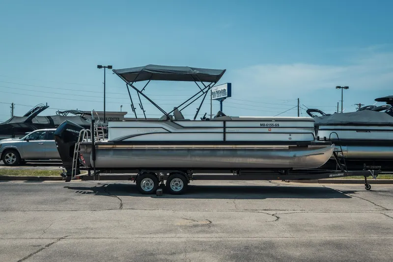Slide: The Image of 2022 Cypress Cay Seabreeze 252 pontoon boat on trailer in parking lot. - 2