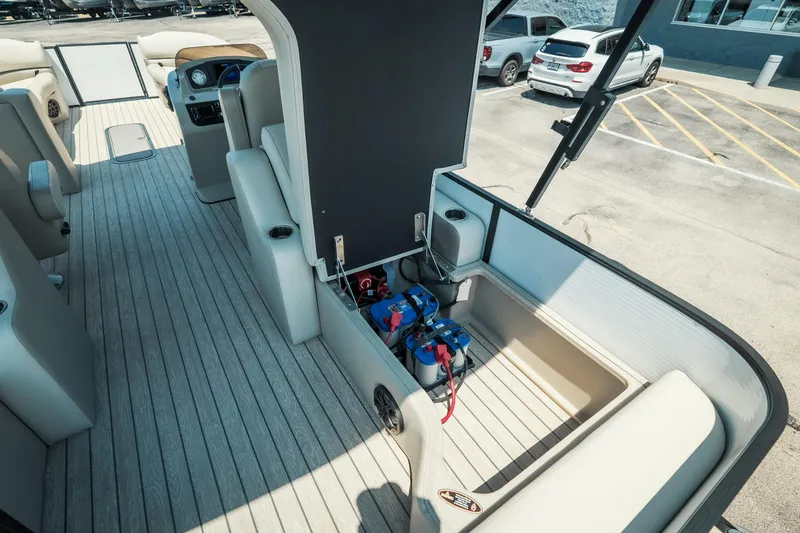 Slide: The Image of 2022 Cypress Cay Seabreeze 252 boat interior with open storage compartment and seating. - 20
