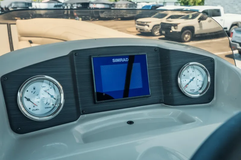 Slide: The Image of Dashboard of 2022 Cypress Cay Seabreeze 252 boat with gauges and Simrad display. - 17
