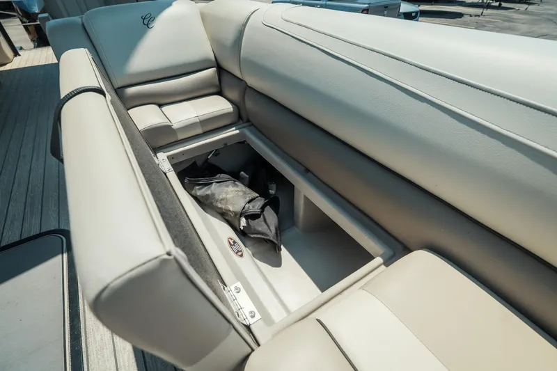 Slide: The Image of Cypress Cay Seabreeze 252 boat seat storage compartment, 2022 model, open with items inside. - 27