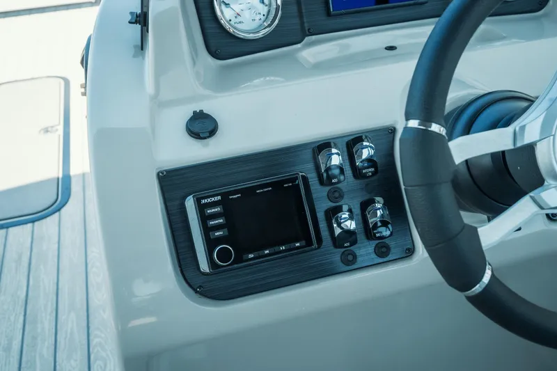 Slide: The Image of Control panel of 2022 Cypress Cay Seabreeze 252 boat with steering wheel and audio system. - 15