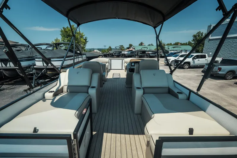 Slide: The Image of 2022 Cypress Cay Seabreeze 252 pontoon boat with spacious seating and canopy in a marina. - 23