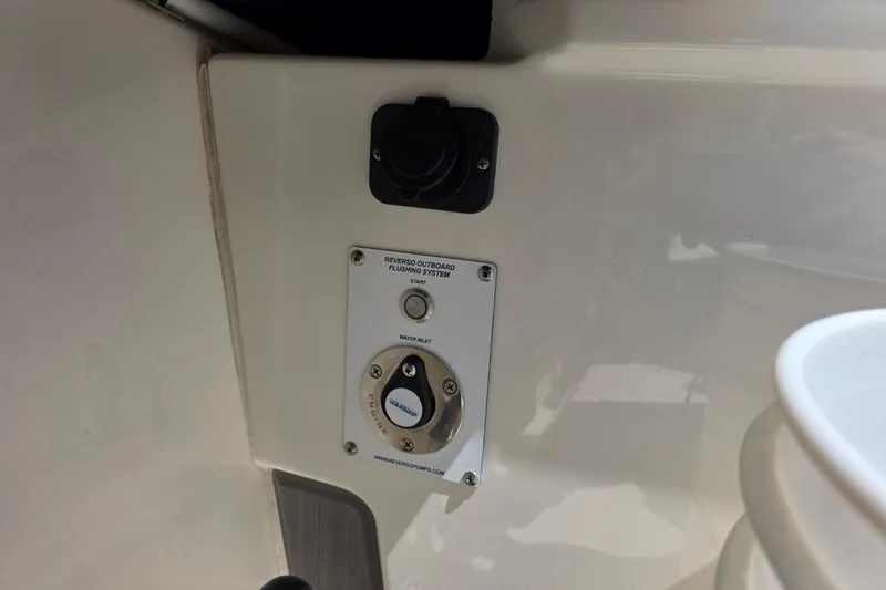Slide: The Image of 2023 Solace 32CS boat's Reverso outboard flushing system control panel. - 15