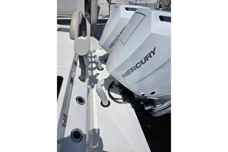 Slide: The Image of 2023 Solace 32CS boat with dual Mercury outboard engines, docked. - 19