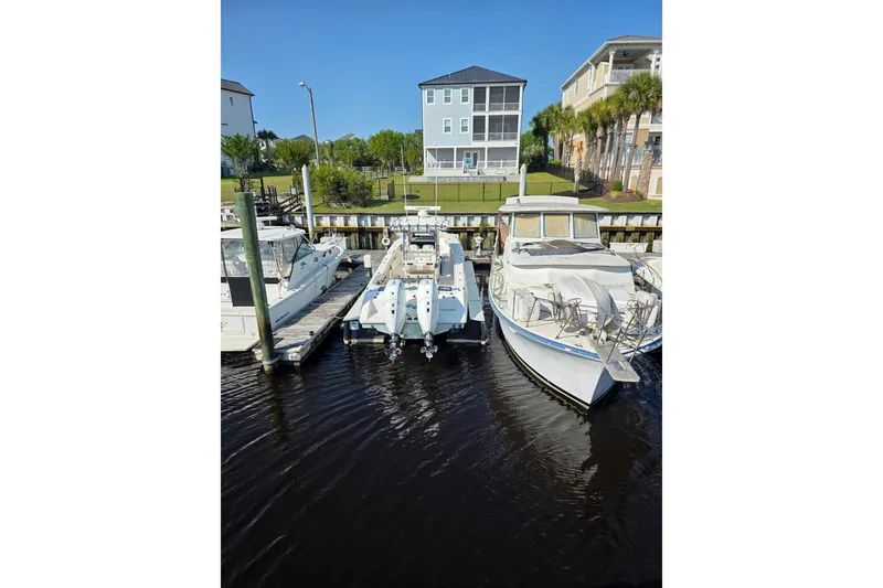 Slide: The Image of Boats docked at a marina, featuring a 2023 Solace 32CS model under clear blue skies. - 3